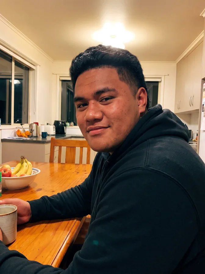 One of the phone photos a parent sent: a fictional football player at the kitchen table at home in a hoodie; photo generated