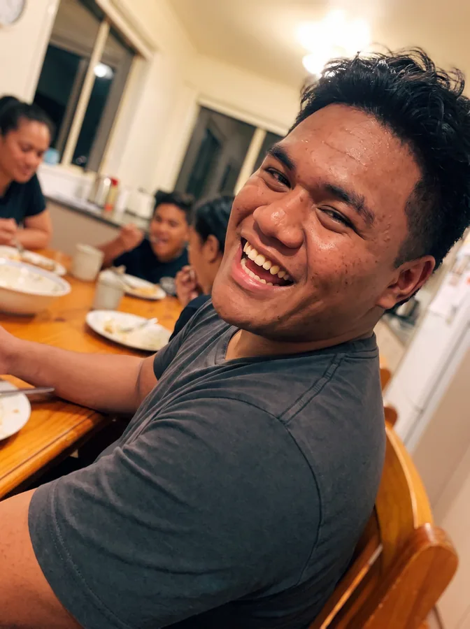 One of the phone photos a parent sent: a fictional football player laughing at the family dinner table; photo generated