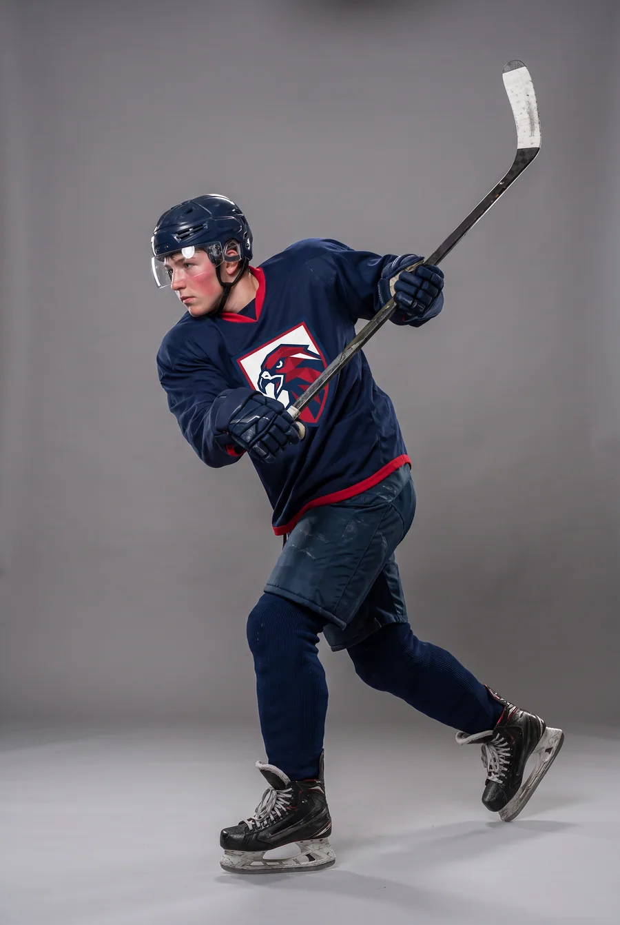 Rejected take from the ice-hockey pilot — the jersey changed between shots: solid navy with a red hem — fictional athlete