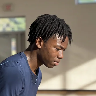 Example of a photo to send: a fictional basketball player at practice with his head turned to the side — generated example photo