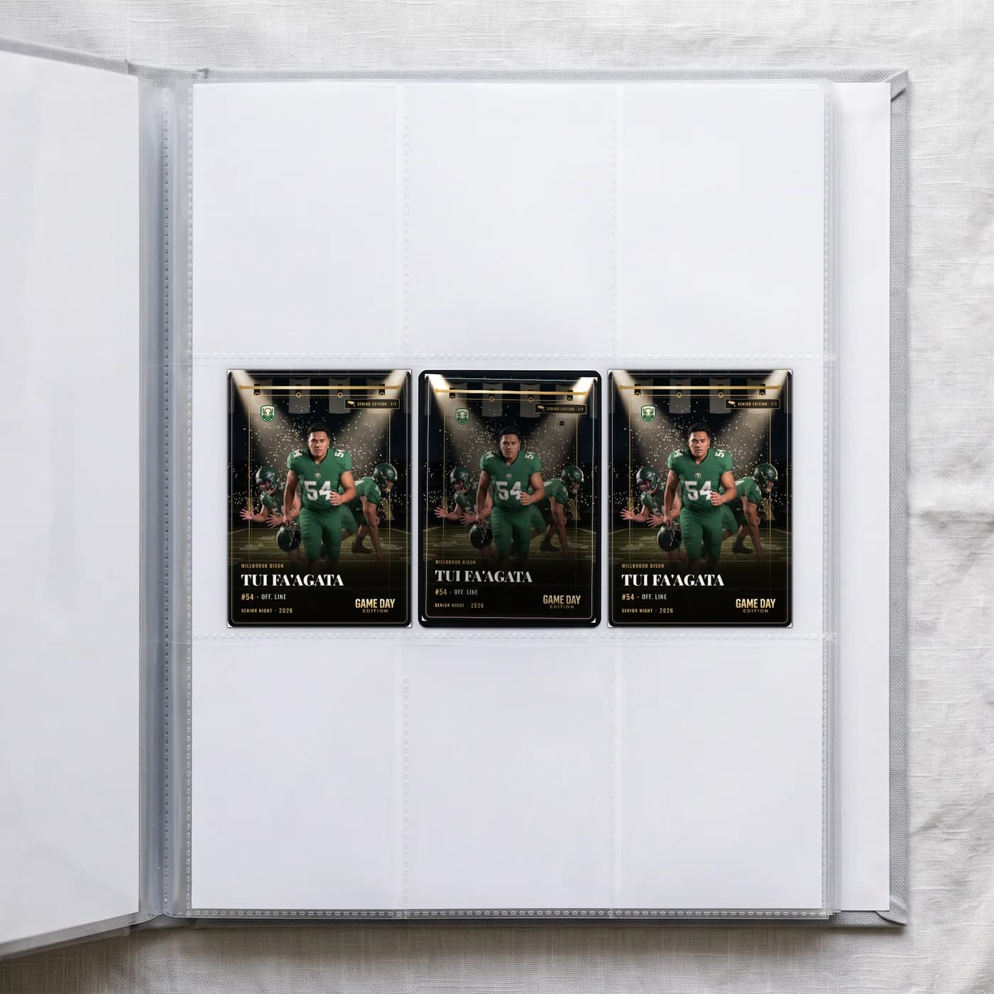 Three custom football trading cards in the sleeves of a collector's binder — Senior Night finish — example artwork, fictional athlete; photo generated